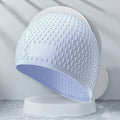 Solid colour silicone swimming cap for adults shown in various colours including Tiffany Blue and Matcha Green.