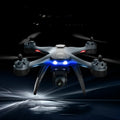 GPS quadrocopter toy drone with remote controller, spare blades, and landing gear on white background