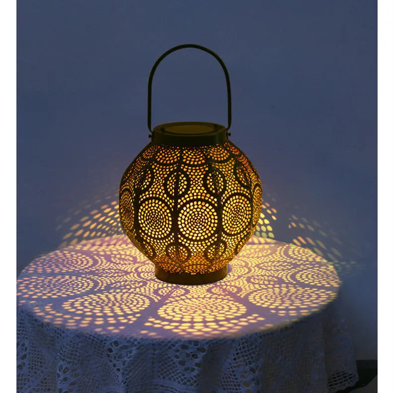 Decorative hollow iron solar courtyard lamp with integrated solar panel and warm white LED illumination