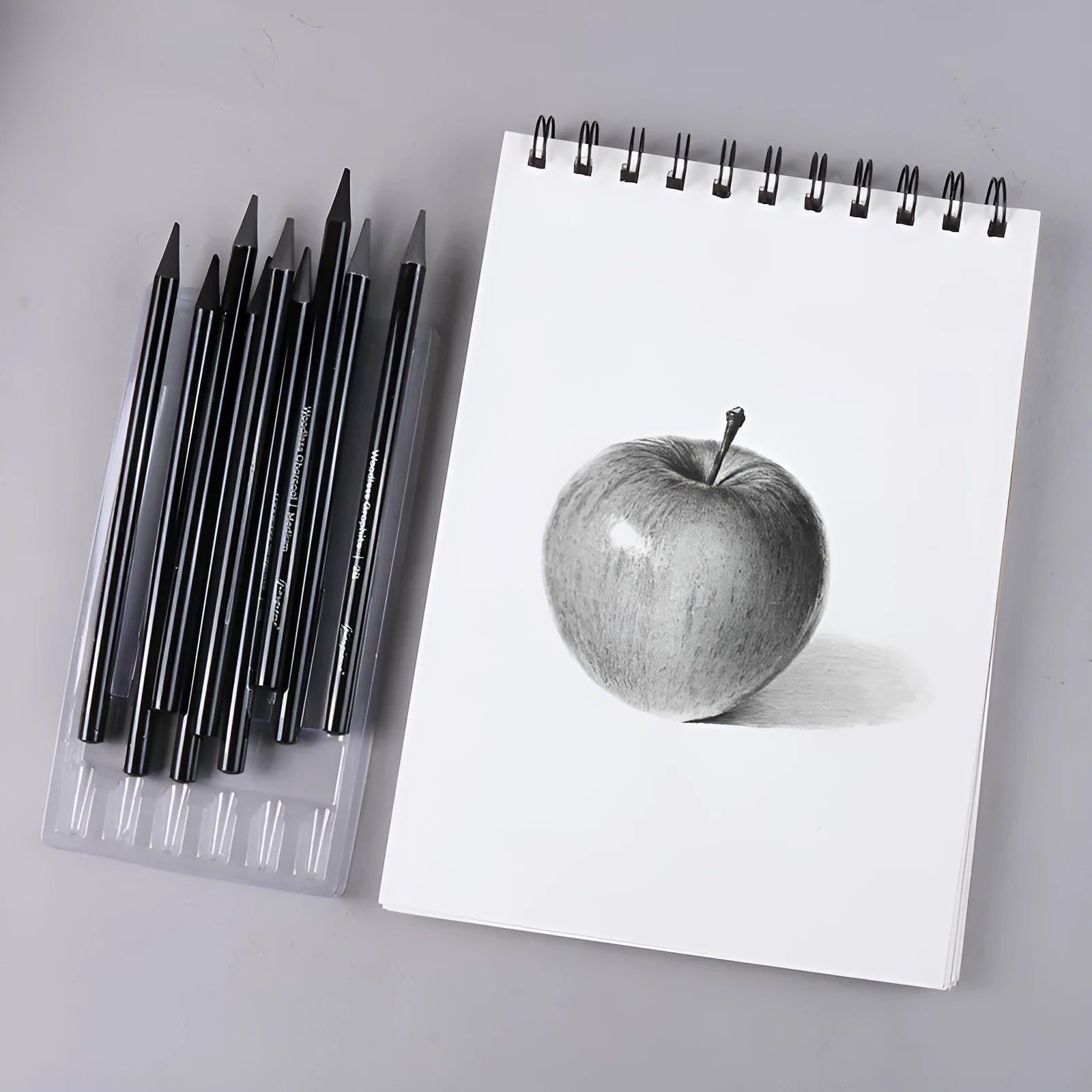 Carbonized pencil set showing 6 graphite and 3 carbonized pencils on suction card packaging