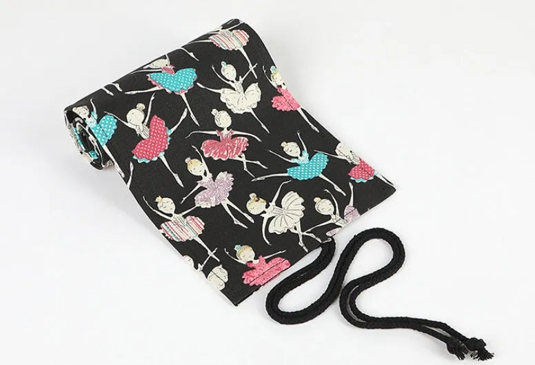 Canvas rolling pencil case with ballet girl print, showing multiple holes for pencils in a rolled-open state.