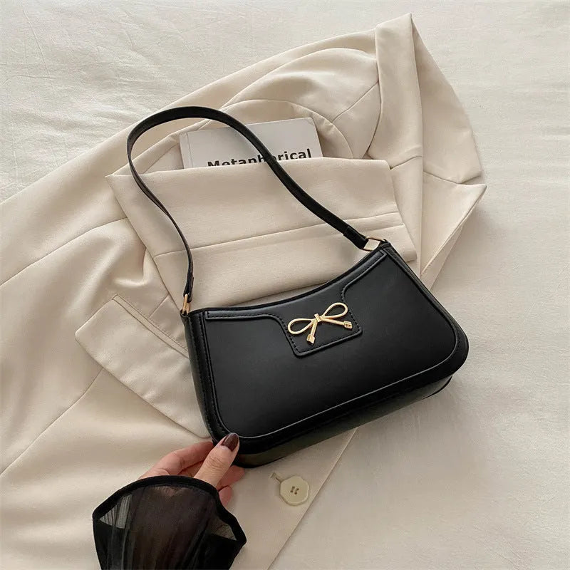 Western style baguette shoulder bag in horizontal square shape with bow decoration, shown in available colours
