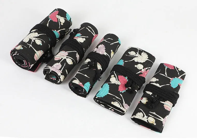 Canvas rolling pencil case with ballet girl print, showing multiple holes for pencils in a rolled-open state.