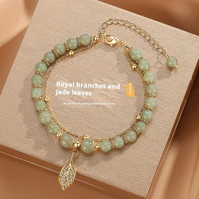 Chinese style handmade glass bead bracelet with bamboo joint elements on a white background.