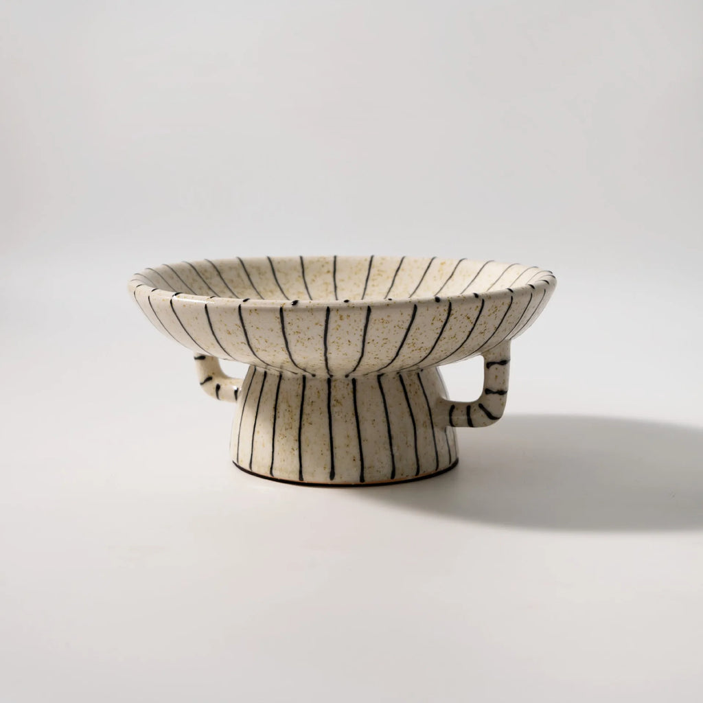 Black and white striped retro synthetic resin dessert plate on a table.