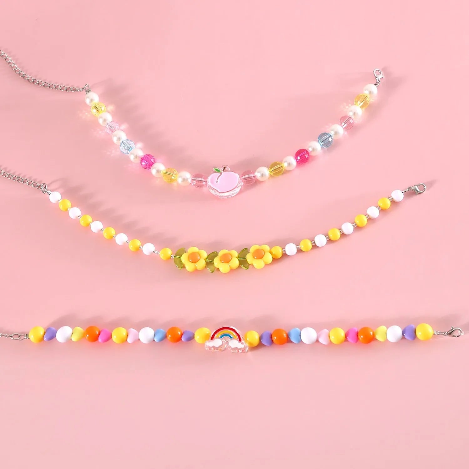 Colourful plastic bead cat necklace with adjustable sizing in peach, rainbow, and small flower patterns