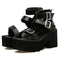Black women's punk-style platform sandals with a chunky heel, thick sole, round toe, and back zipper.