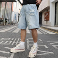 Light blue loose-fit ripped denim shorts with distressed details on a straight-leg silhouette.