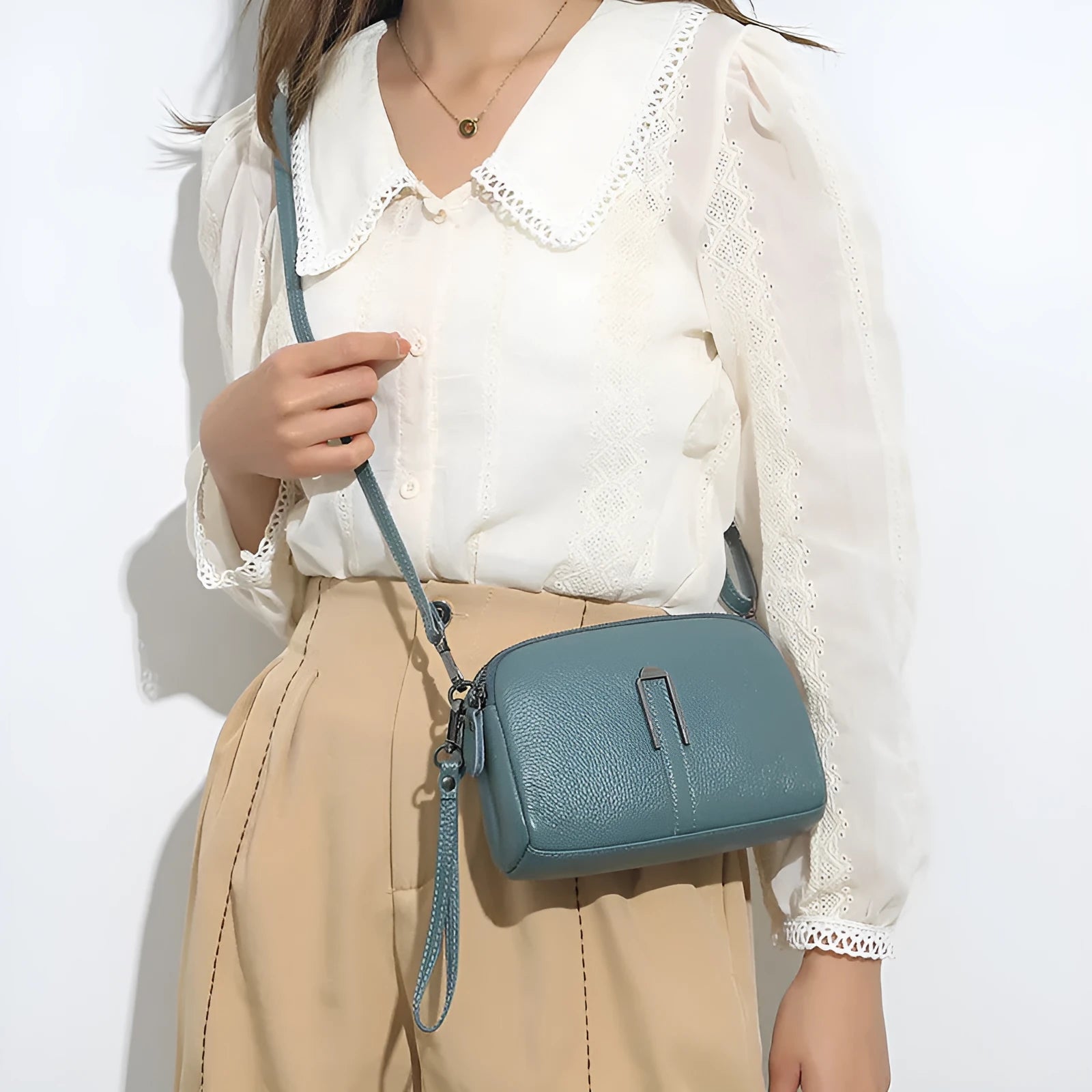 Square genuine leather ladies shoulder bag in dark khaki colour showing structured silhouette.