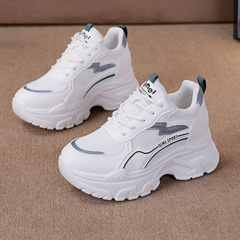 Women's white and beige dad shoes with cross shoulder straps and lace-up front, showing round toe.