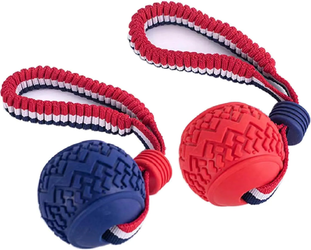 Red rubber dog ball with rope attachment for tug of war and teeth cleaning