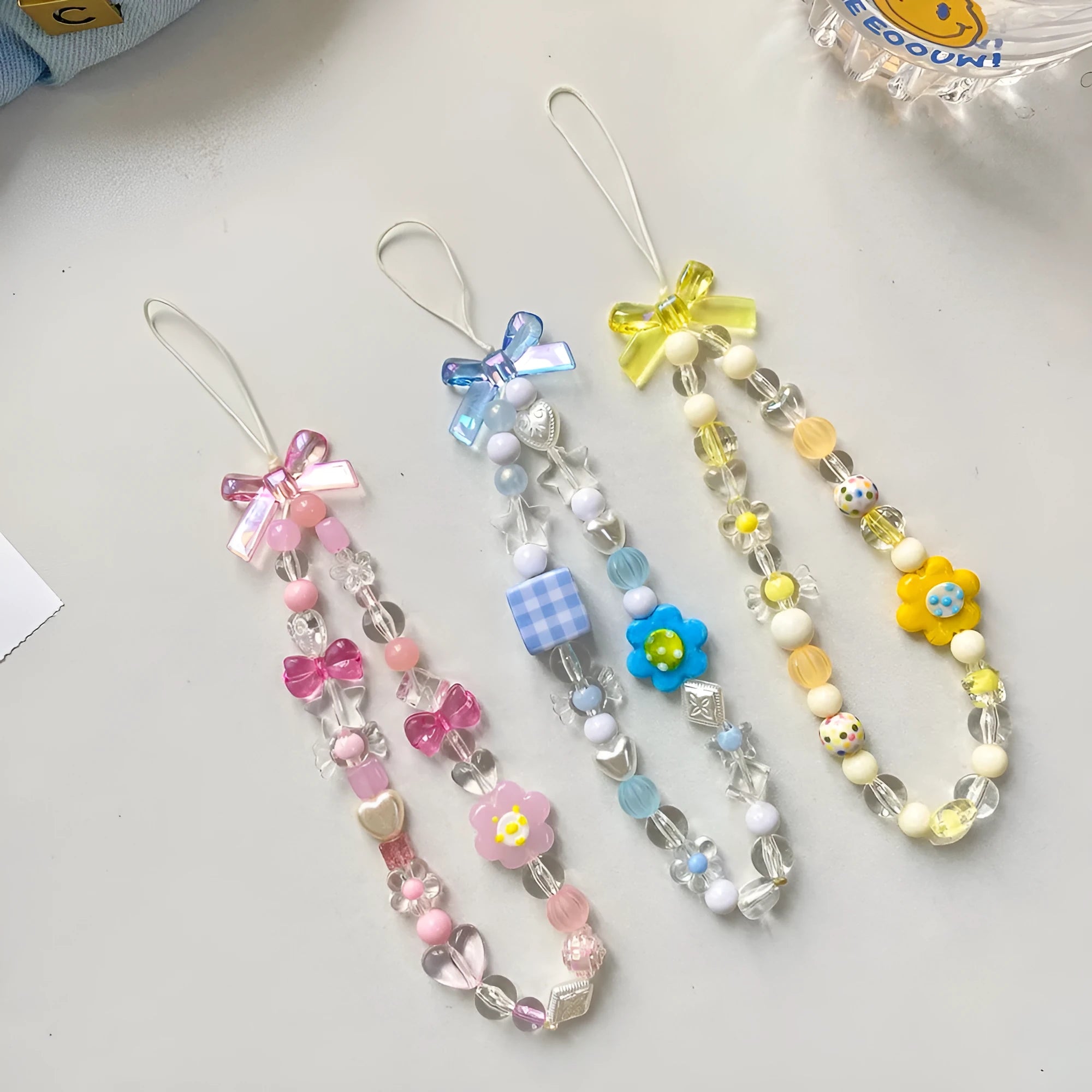Flower bead mobile phone lanyard with hand rope in yellow, blue, and pink colour options