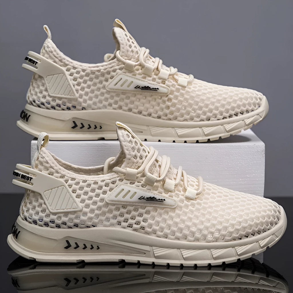 Men's beige casual sneaker with mesh lining, synthetic leather upper, and lace-up front on a low EVA sole.