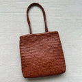 Handmade brown woven tote bag made from vintage top layer cowhide leather with a three-dimensional pocket.
