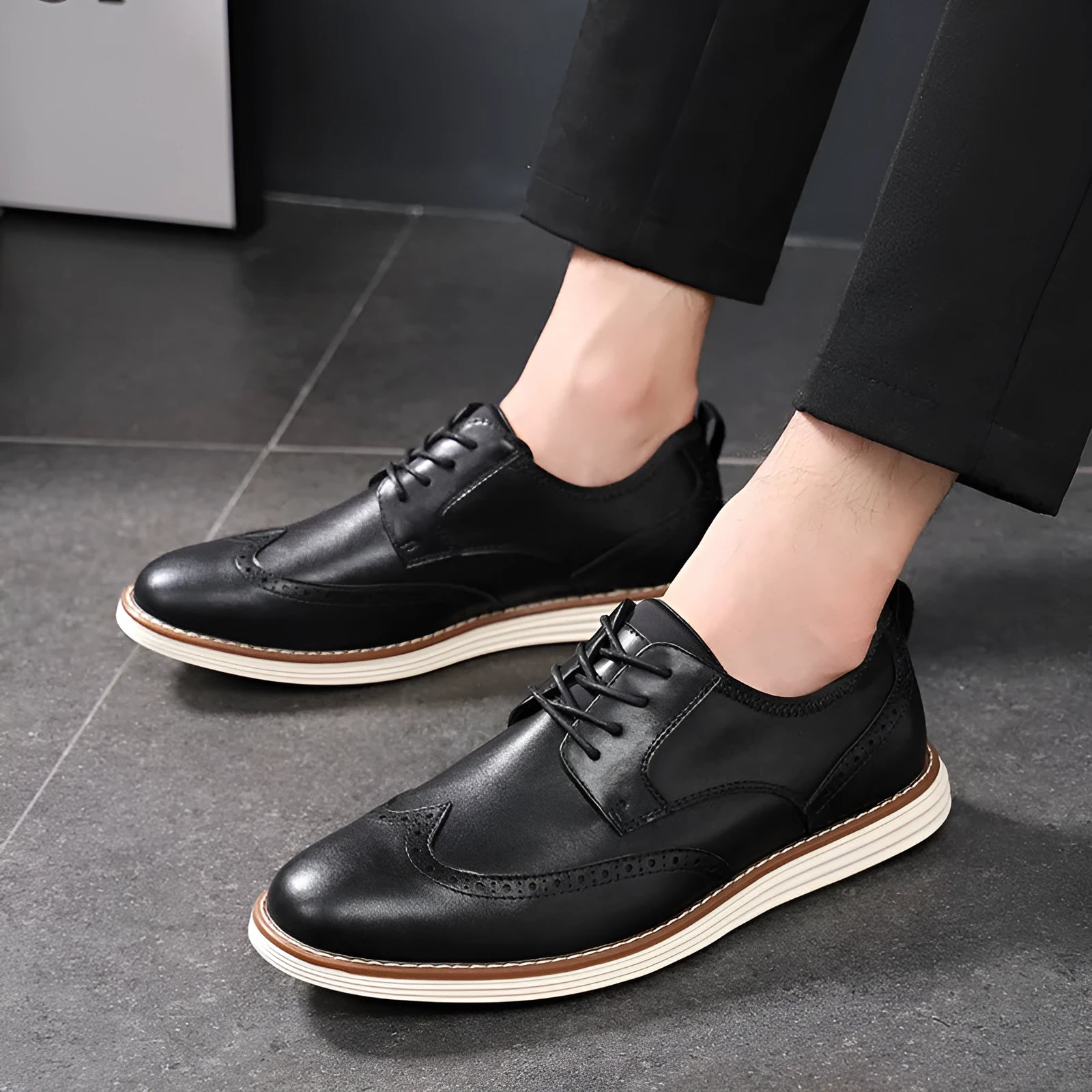 Men's black slip-on casual shoes with round toe and carving design on PU upper
