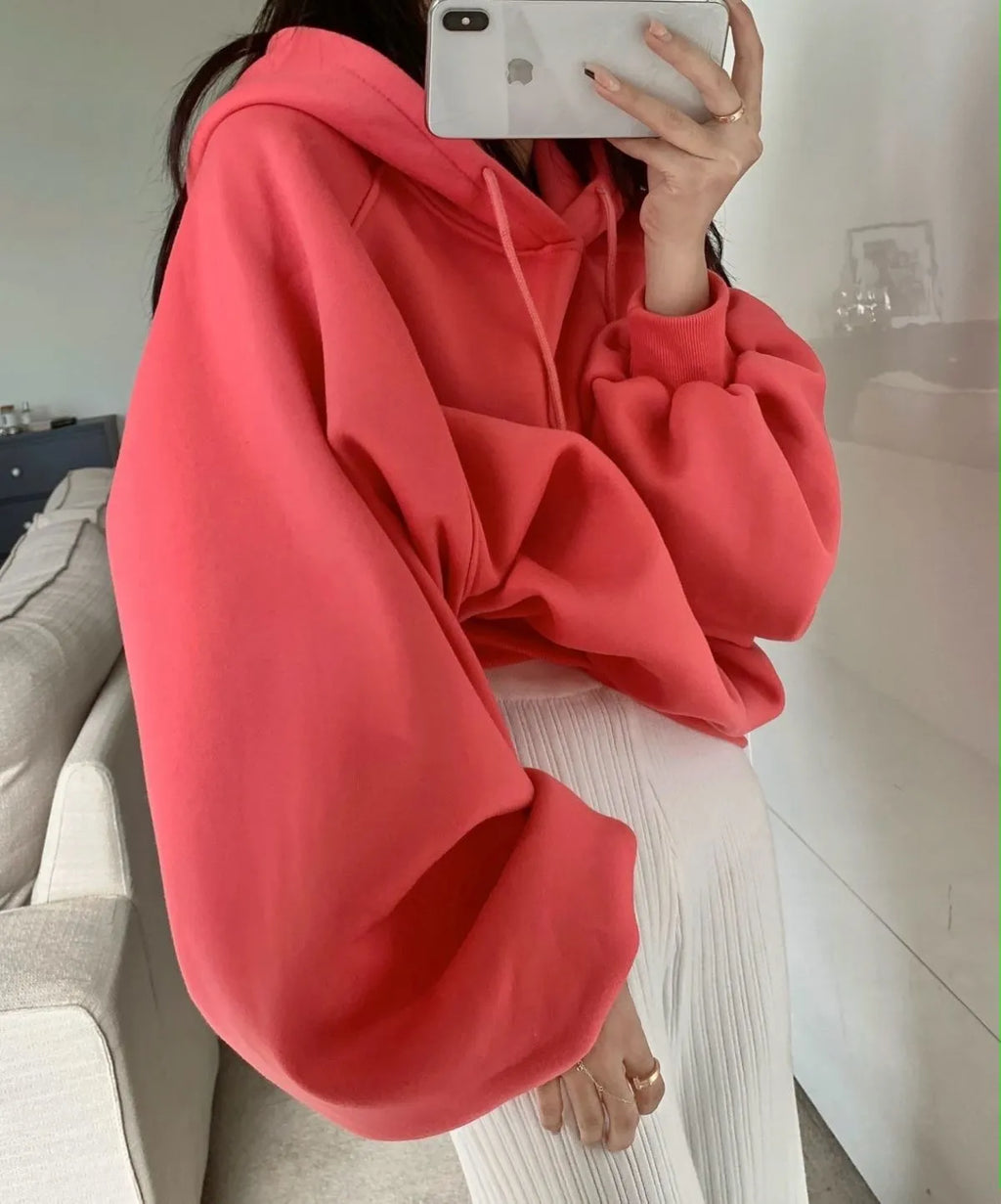 Women's loose watermelon red hooded sweater made from Mulberry Silk, shown on a hanger.