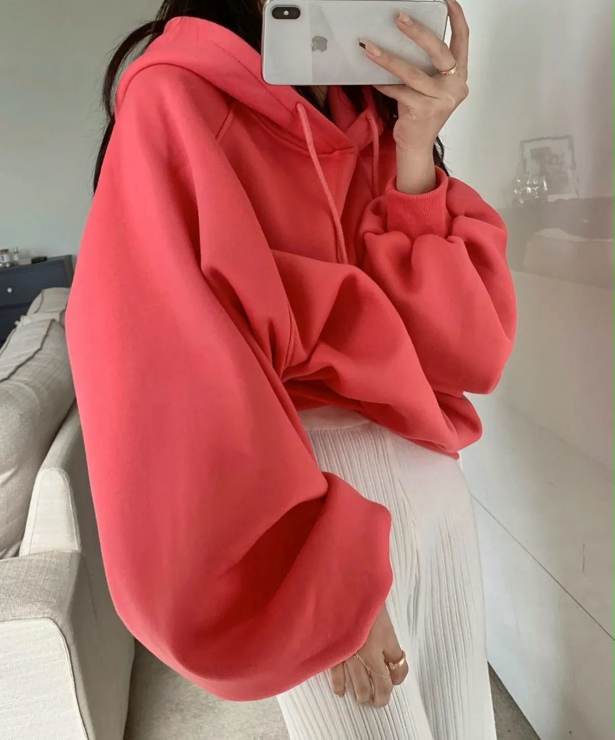 Women's loose watermelon red hooded sweater made from Mulberry Silk, shown on a hanger.