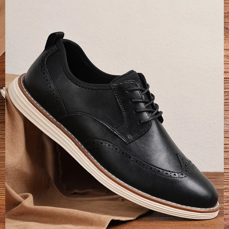Men's black slip-on casual shoes with round toe and carving design on PU upper