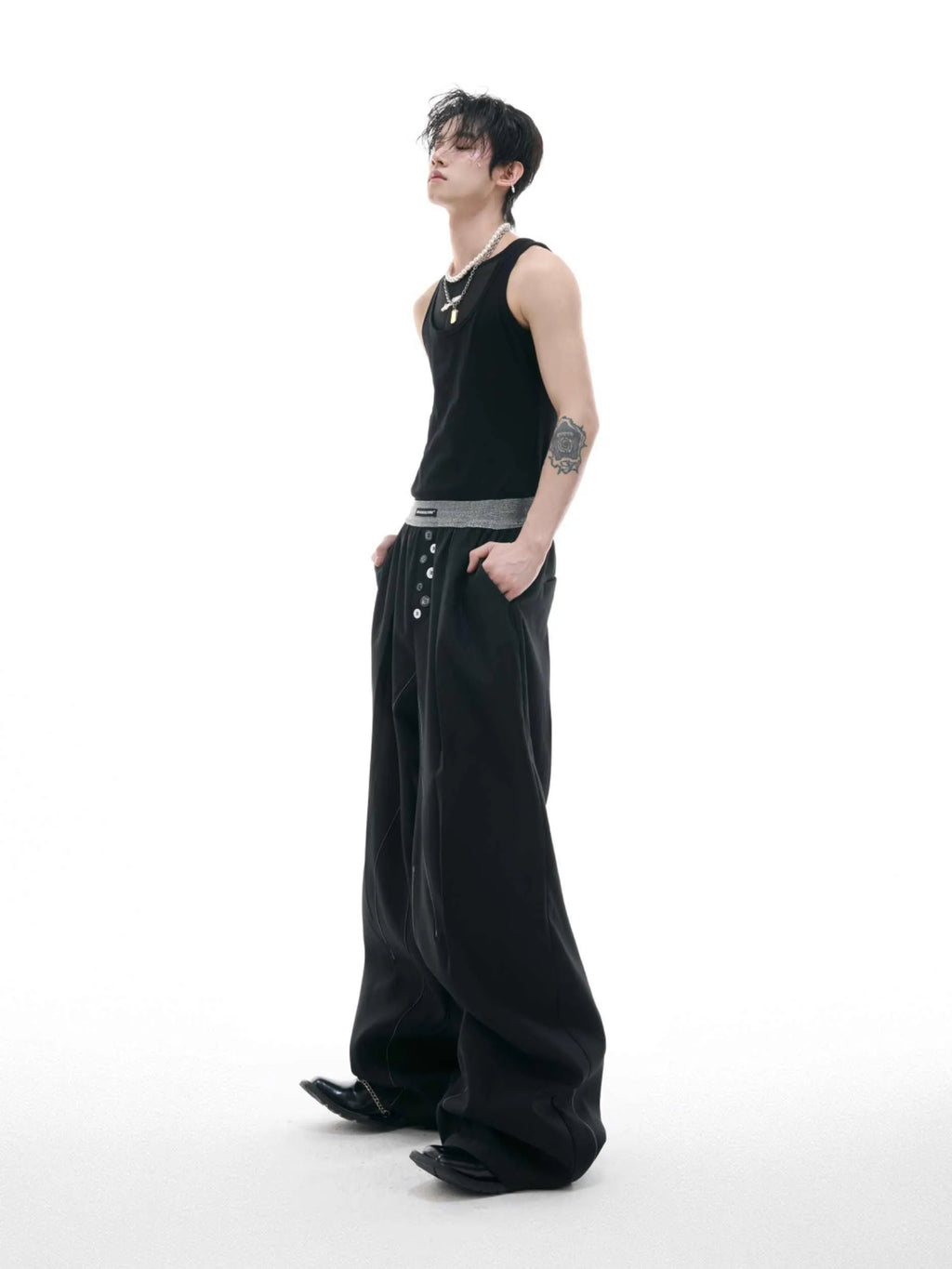 Drooping straight-leg casual trousers with button open line detail in black or grey colours