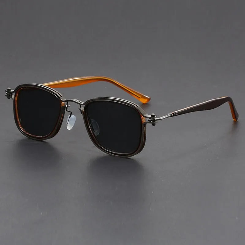 Retro square frame sunglasses with AC lenses in a black gold and grey colour combination.