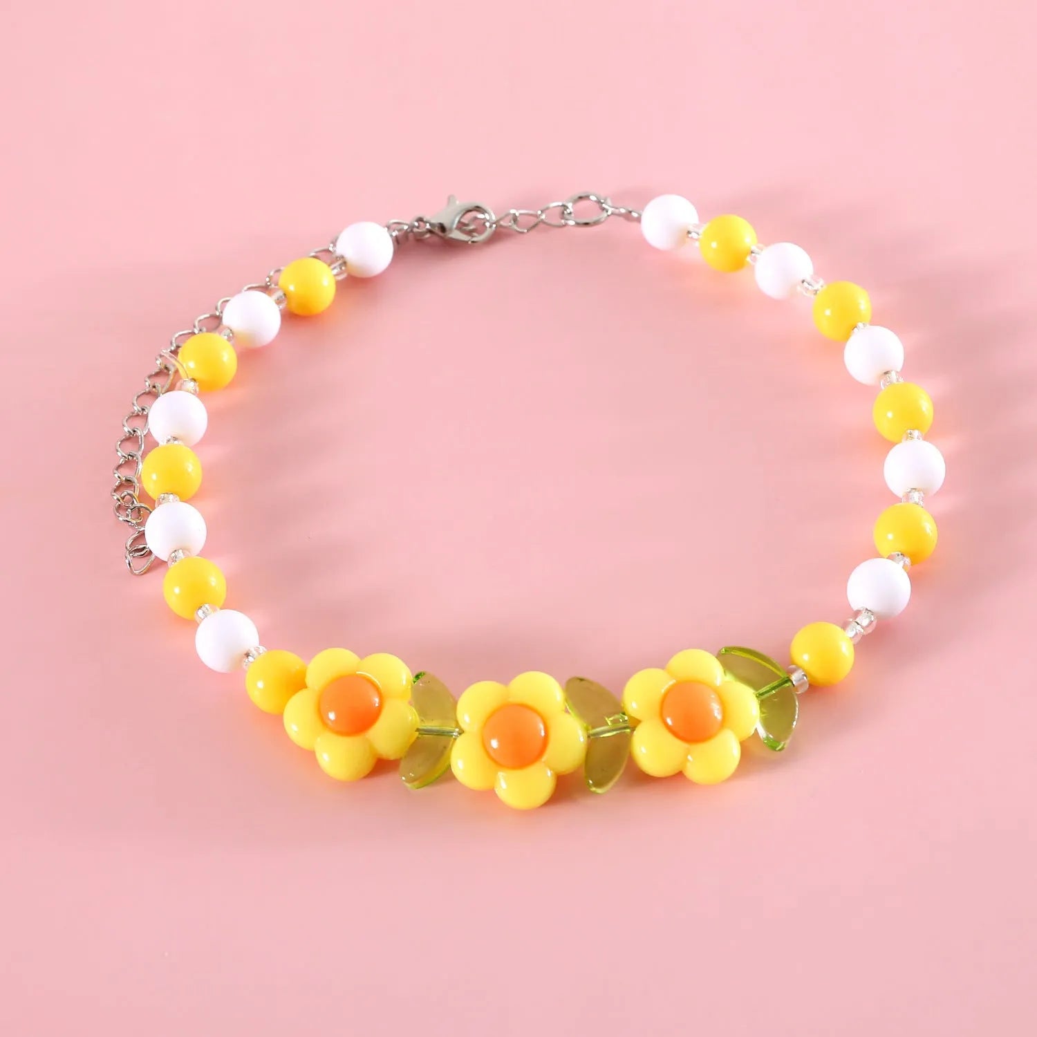 Colourful plastic bead cat necklace with adjustable sizing in peach, rainbow, and small flower patterns