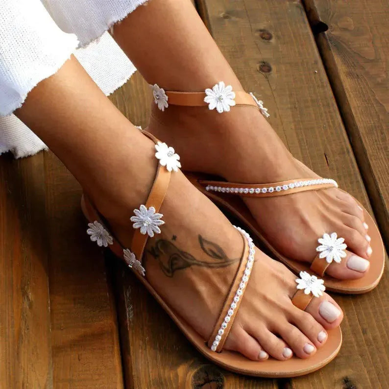 Brown women's Roman sandals with floral pattern and flat rubber sole