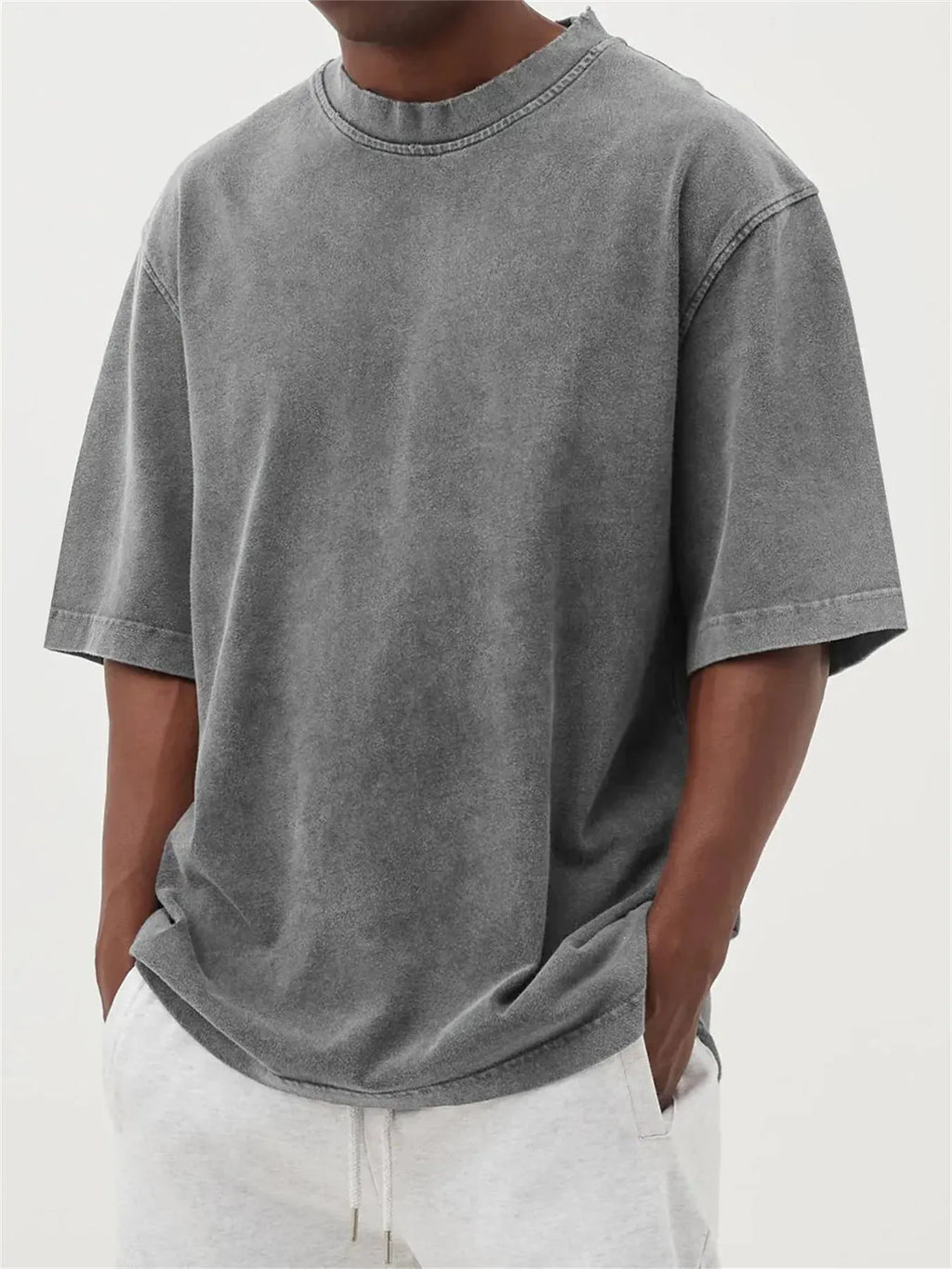 Men's stone-washed distressed loose fit t-shirt in army green colour on a hanger.