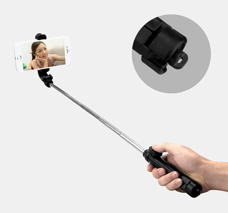 Black Bluetooth selfie stick with extended tripod legs and a phone clip rotated for horizontal filming.
