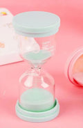 Glass sand timer with coloured sand in modern design showing timing duration options