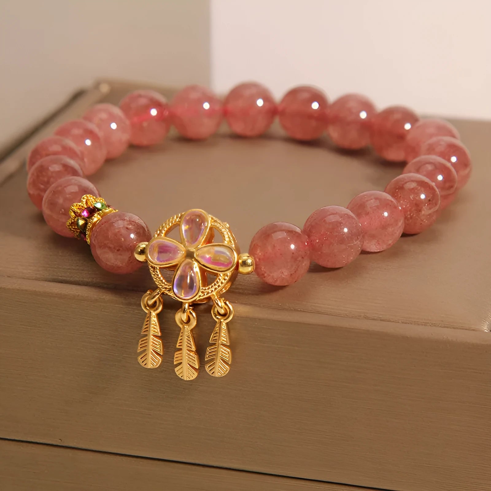 Women's strawberry quartz crystal bracelet with four leaf dream catcher ball pendant
