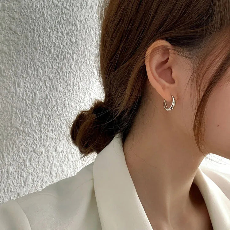 Geometric water drop shaped copper earrings with a minimalist design in a gold electroplated finish.