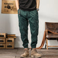 Men's cotton harem pants in khaki with tapered legs and ankle band.