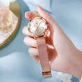 Women's fashion watch with rose gold alloy shell and mesh strap showing six dial colour options