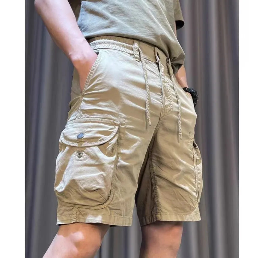 A pair of loose-fitting, straight-leg casual overalls in a khaki colour with multiple visible pockets.