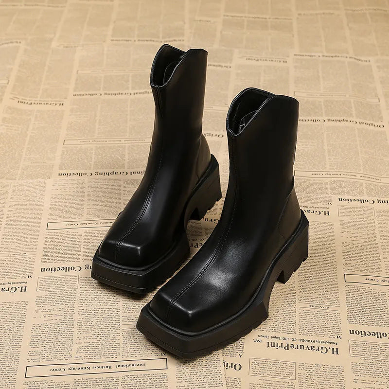 Black square toe platform Martin boots for women with a chunky rubber sole and back zip.