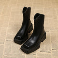 Black square toe platform Martin boots for women with a chunky rubber sole and back zip.