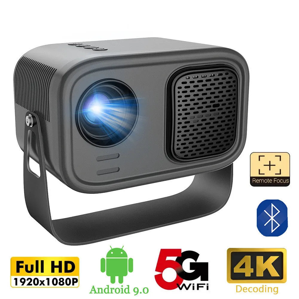 Black portable smart projector with remote control and cables on desk