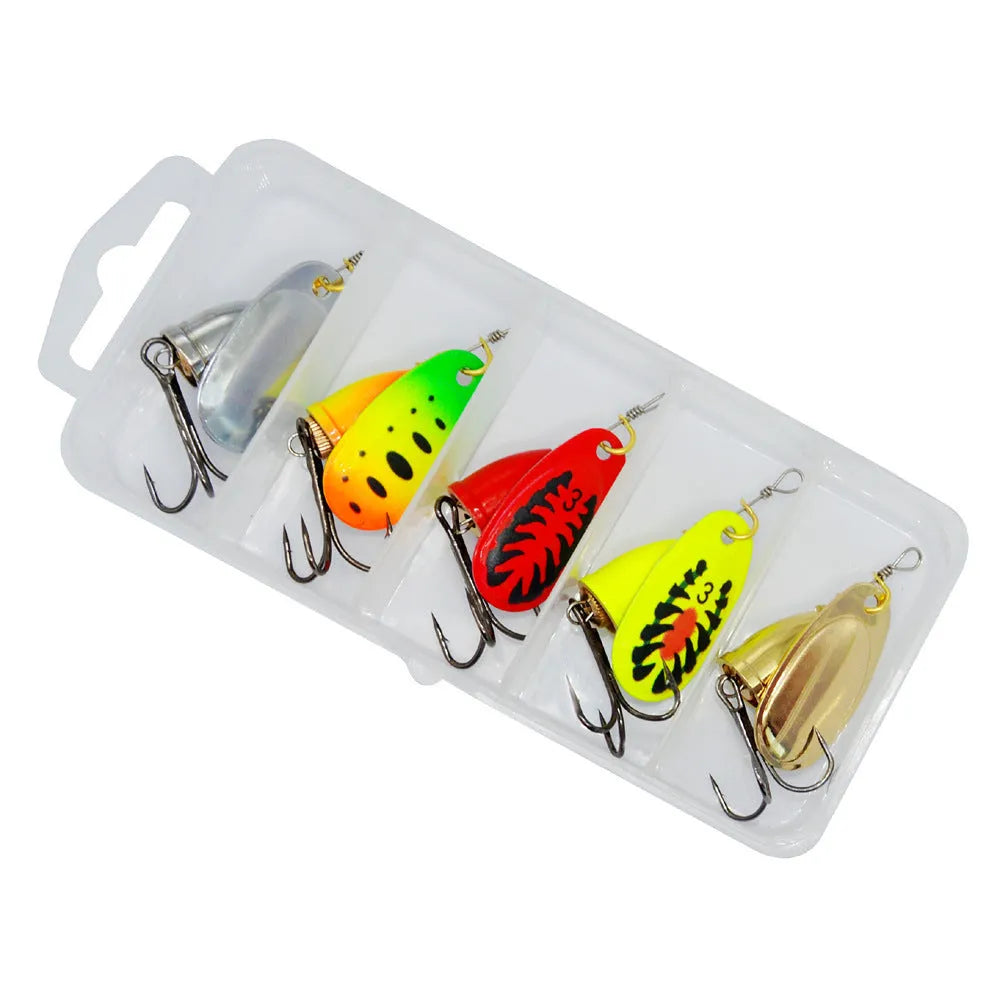 Rotating composite sequin copper bell metal fishing lure in seven colour variations on tackle background
