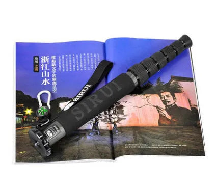 Black carbon fibre SLR camera monopod with 6 telescoping sections shown at extended height