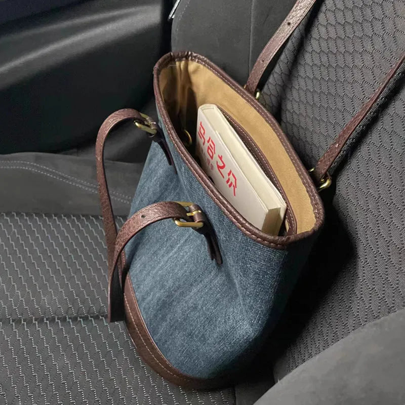 Denim patchwork handbag with one-shoulder bucket design showing dimensions