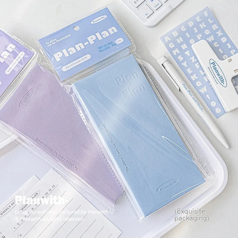 Embossed A5 daily meter book notebook showing blue, grey, purple, and white cover colour options.
