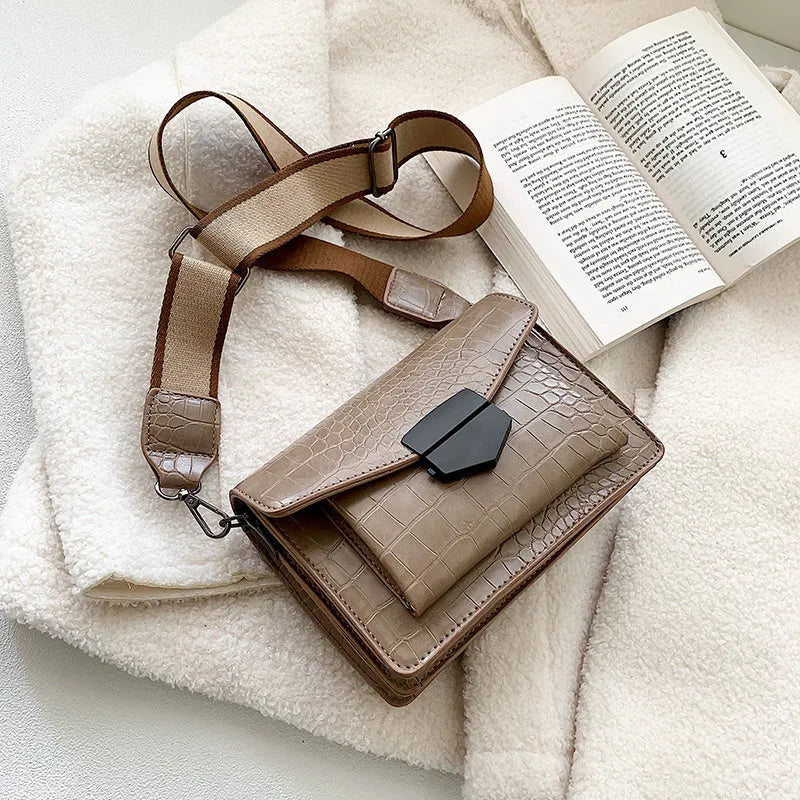 Vintage PU leather crossbody bag in black, shown with adjustable strap.