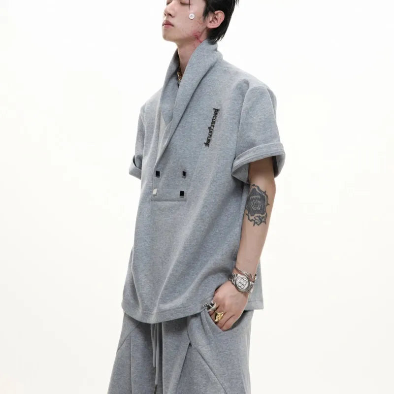 Men's dark grey cotton sports suit with padded shoulders, metal embellishments, V-neck, and matching shorts