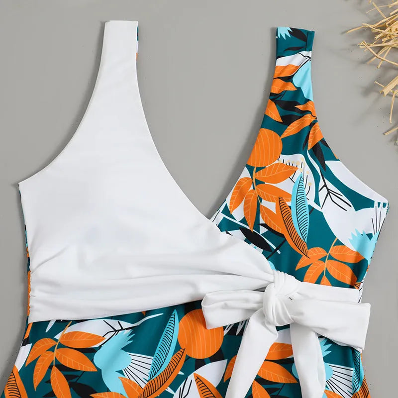 Women's high-waist one-piece swimsuit in a printed pattern, showing conservative cut and style.