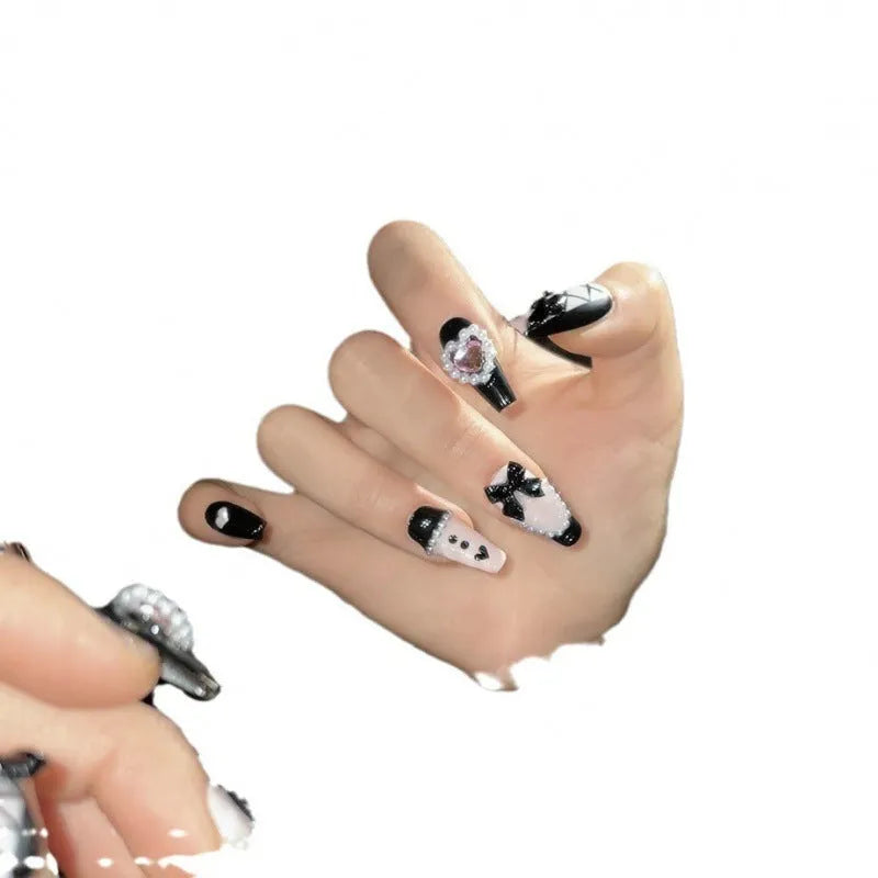 Black peach heart hand-painted false nails with cat's eye style and bow patterns