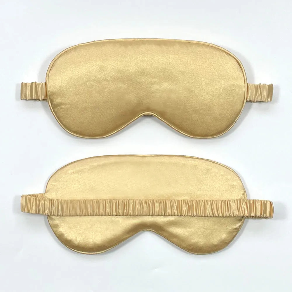 Double-sided silk-like sleep mask in rayon elastic satin shown in multiple colour options on a grey background.