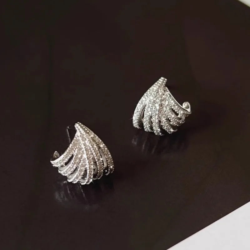 Pair of geometric line design earrings with platinum electroplated finish on zircon.