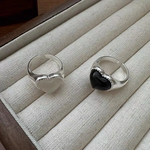 Adjustable opening sterling silver ring with black agate heart stone design on finger