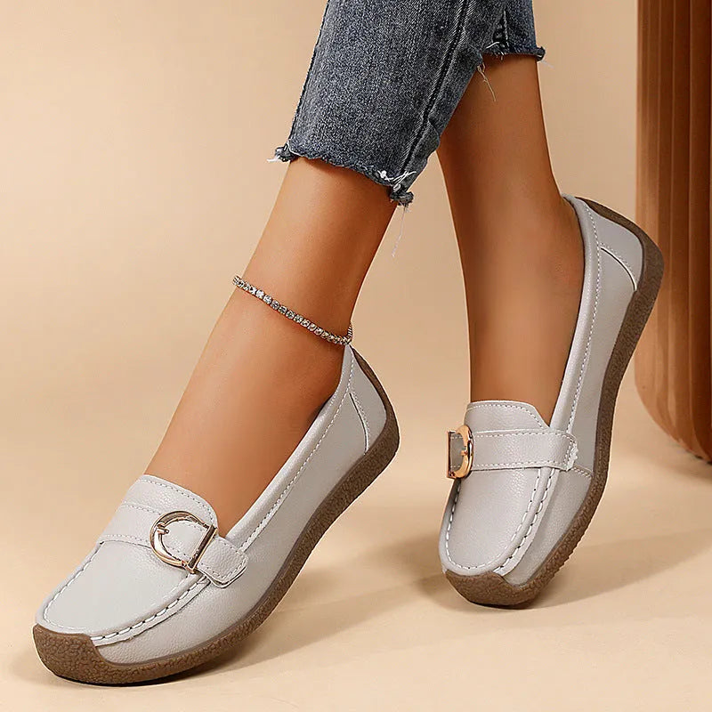 Women's beige casual loafers with a round toe and flat heel on a soft beef tendon sole.