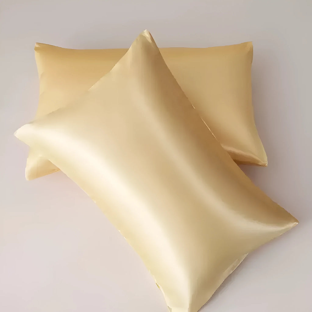 A pair of solid-colour satin pillowcases in polyester fibre, shown in one of thirteen available colours.
